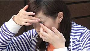 lady removing contact lens