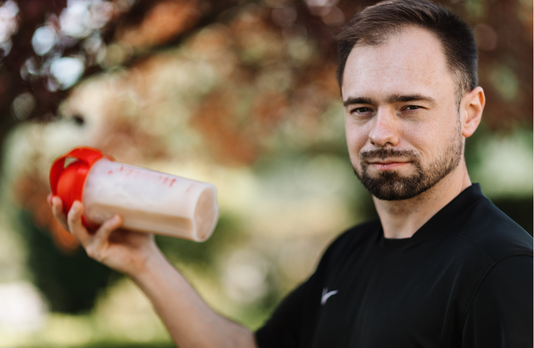 man shaking a protein